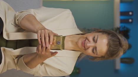 Vertical-video-of-Home-office-worker-woman-texting.